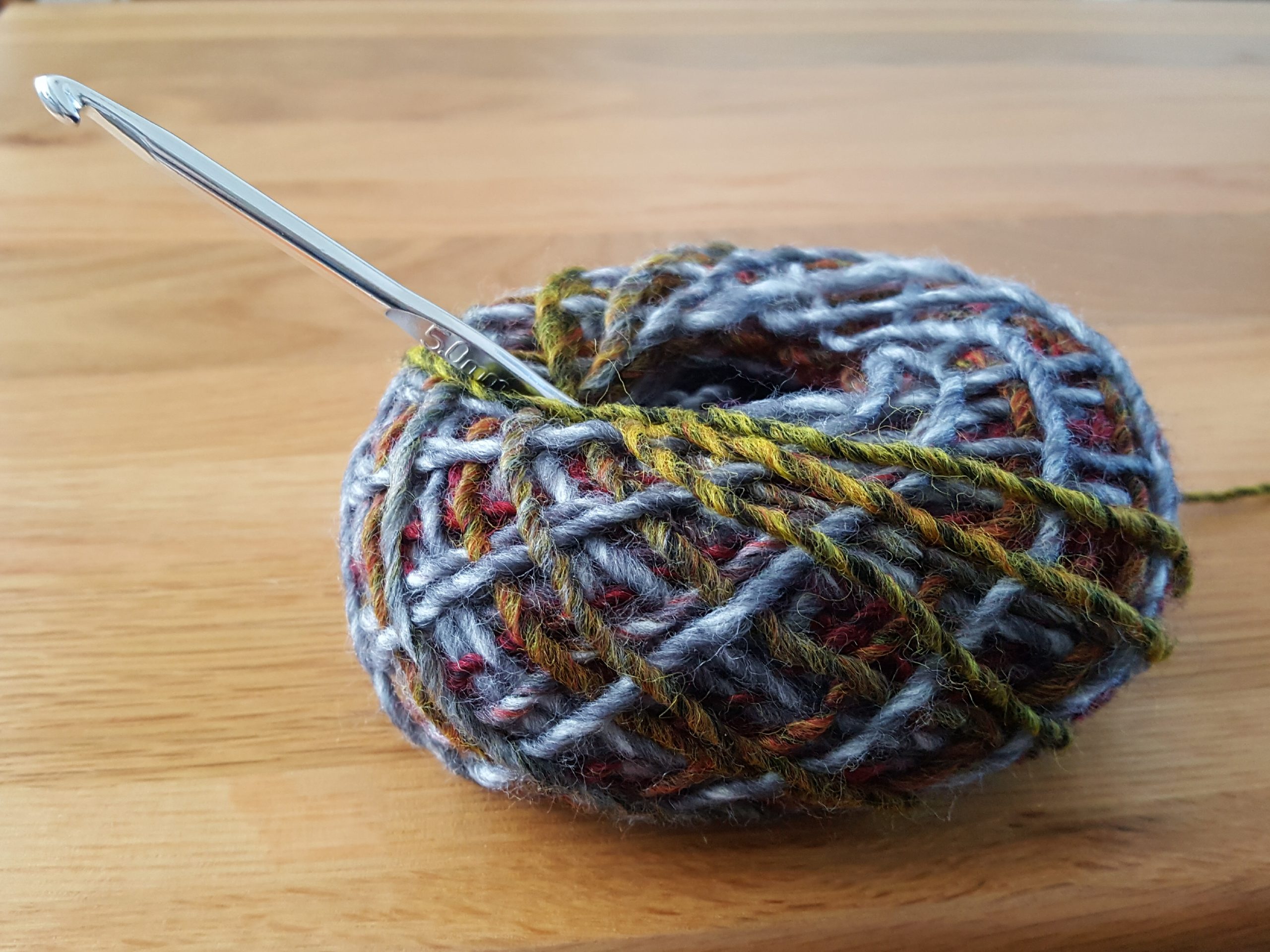 Crochet hook and ball of yarn