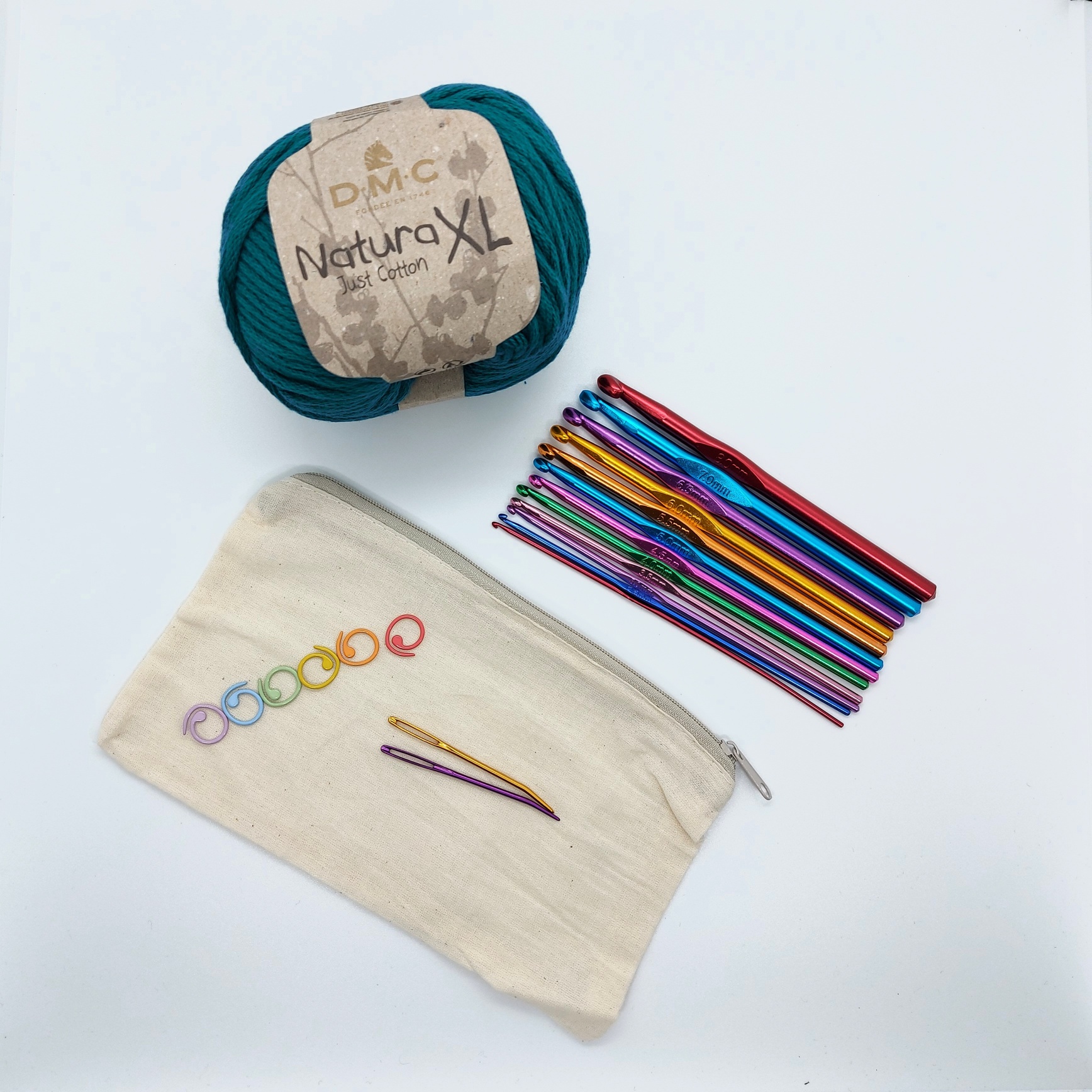Crochet kit made of a set of hooks, a ball of yarn, bendy needles and stitch markers, with a zipped fabric pouch